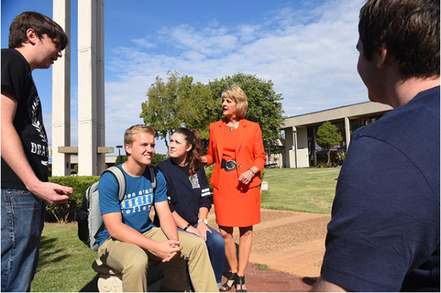 Jeanie Webb, President of Rose State College, chats with a group of students out on the campus. (Mark Hancock)