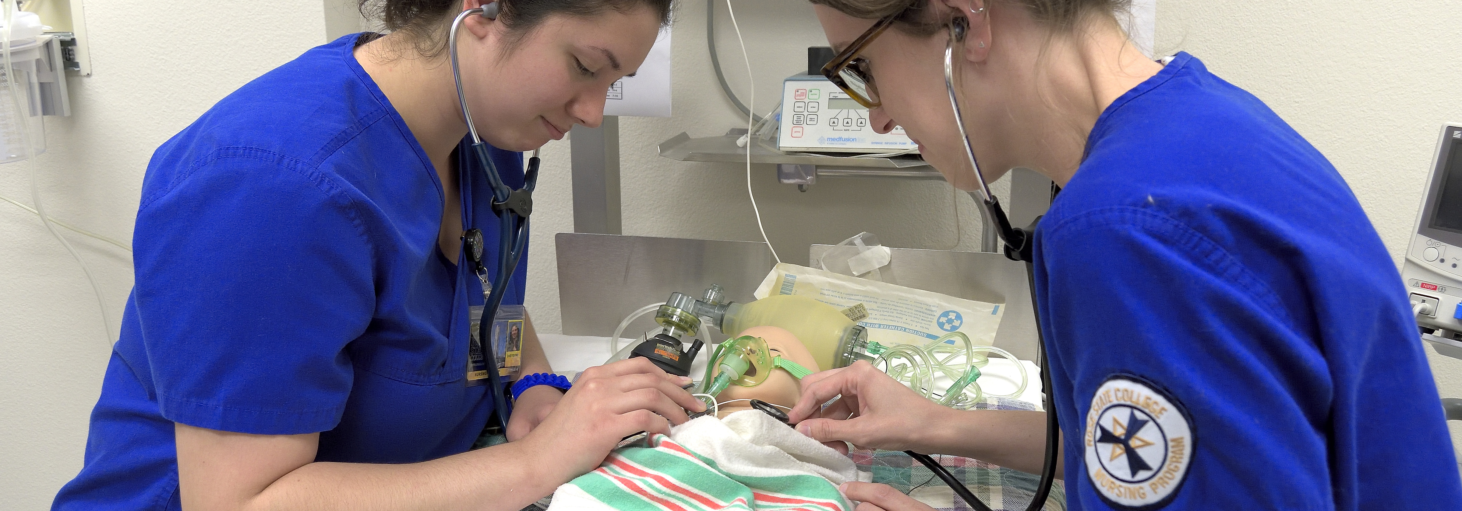 two nursing students working on a dummy