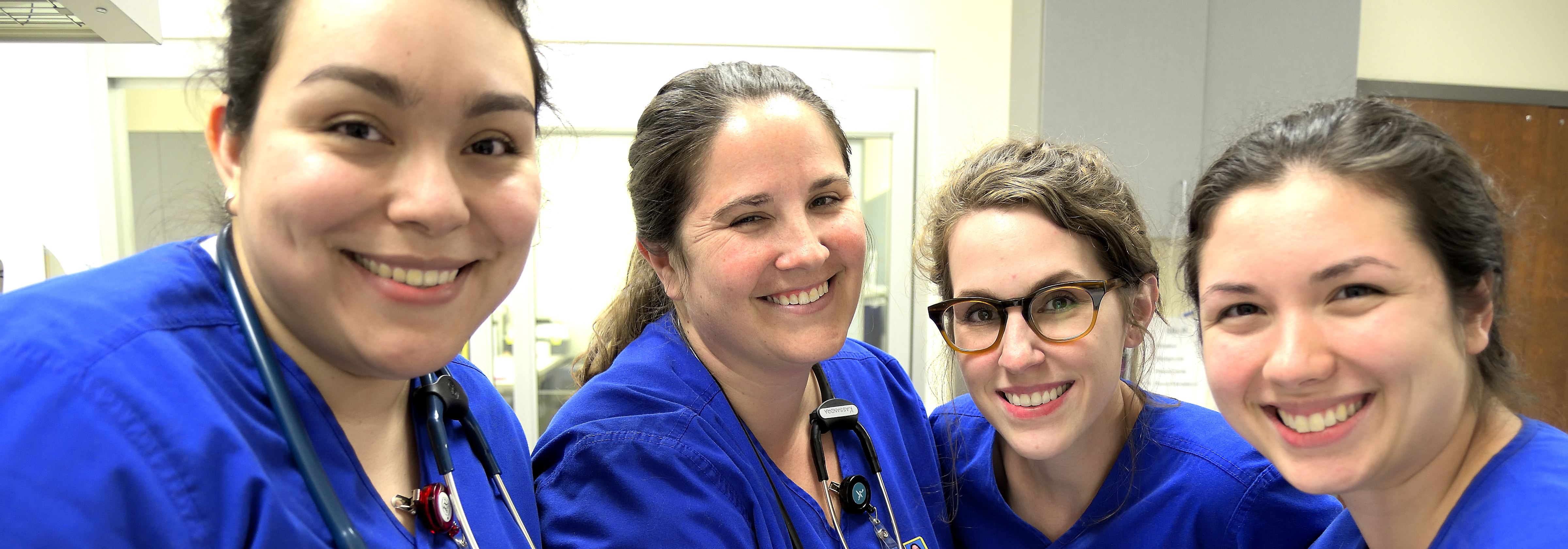 four smiling nursing students