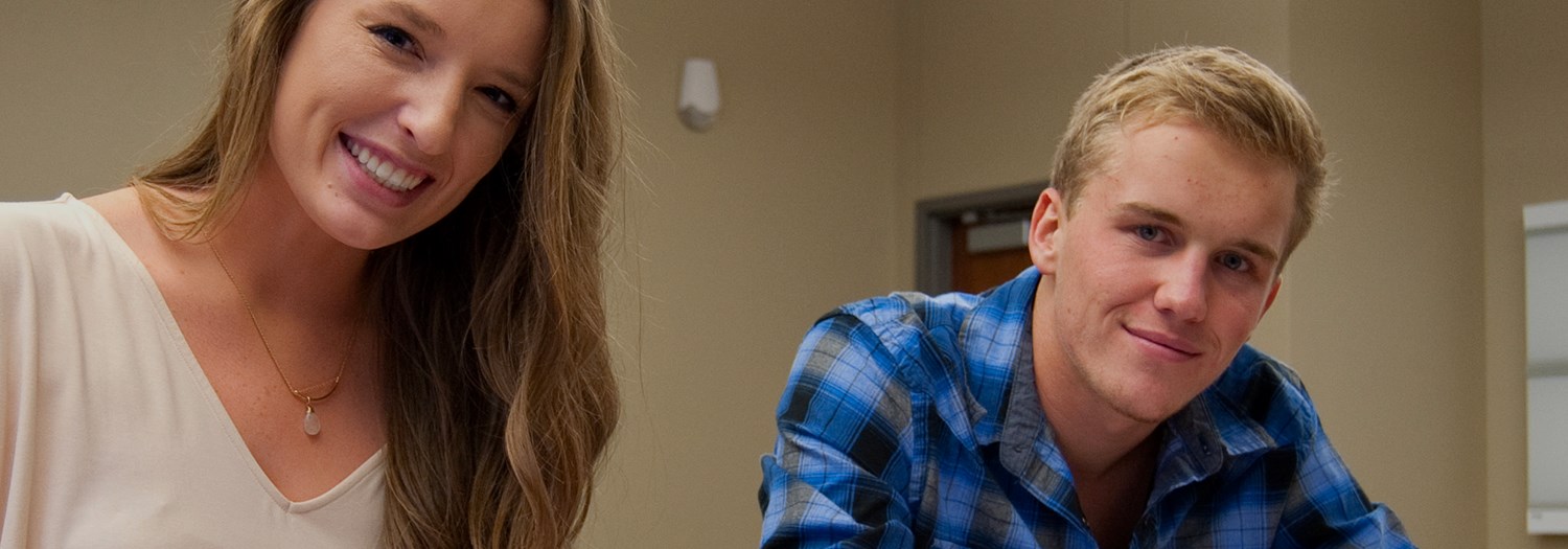 Female and male student smiling for the photo