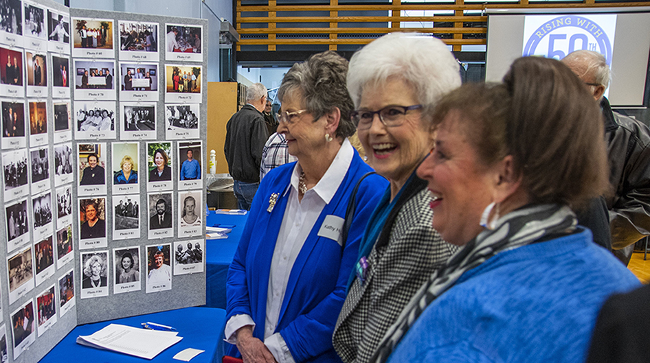 Pictured are attendees helping identify archive photos of Rose State administrators, faculty and staff.
