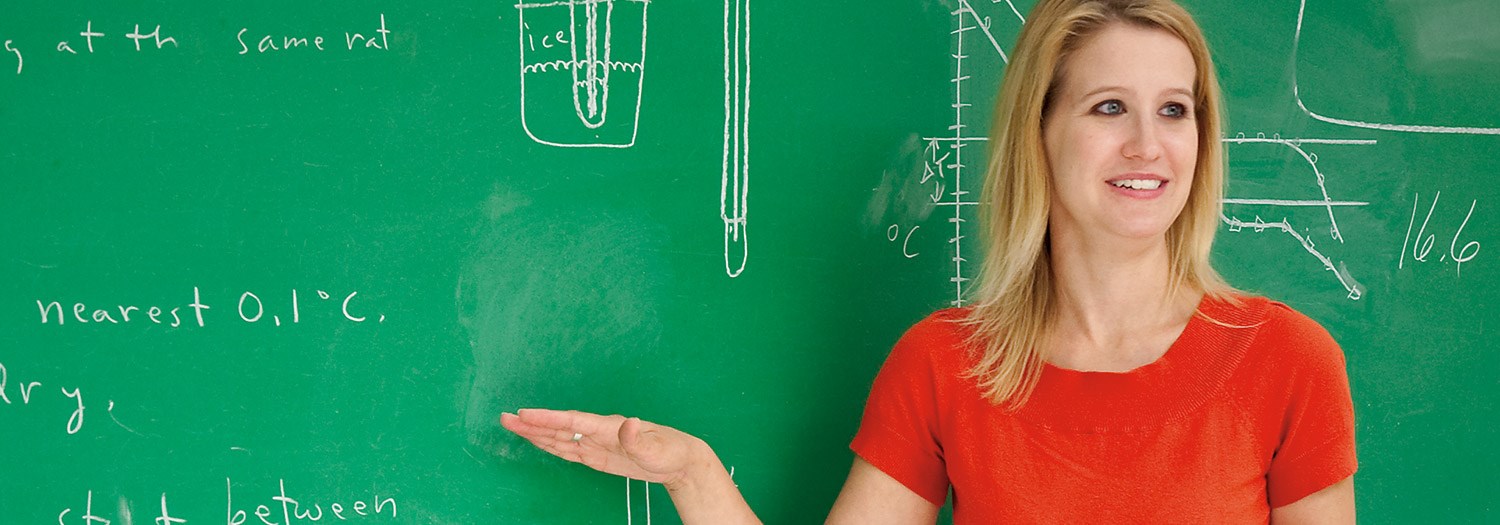 Mathematics professor explaining work shown on a chalkboard