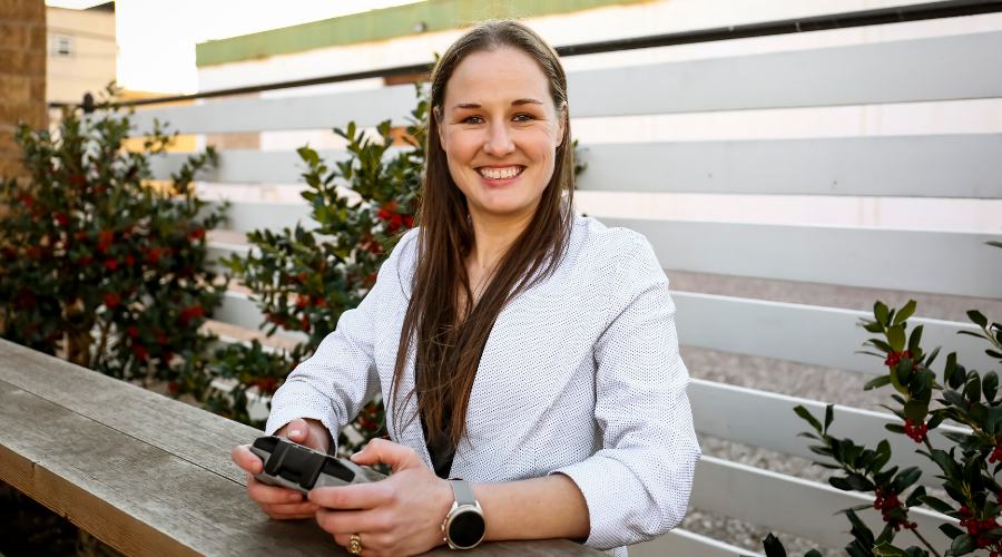 Nicole Whisenhunt, smiling holding the drone controller