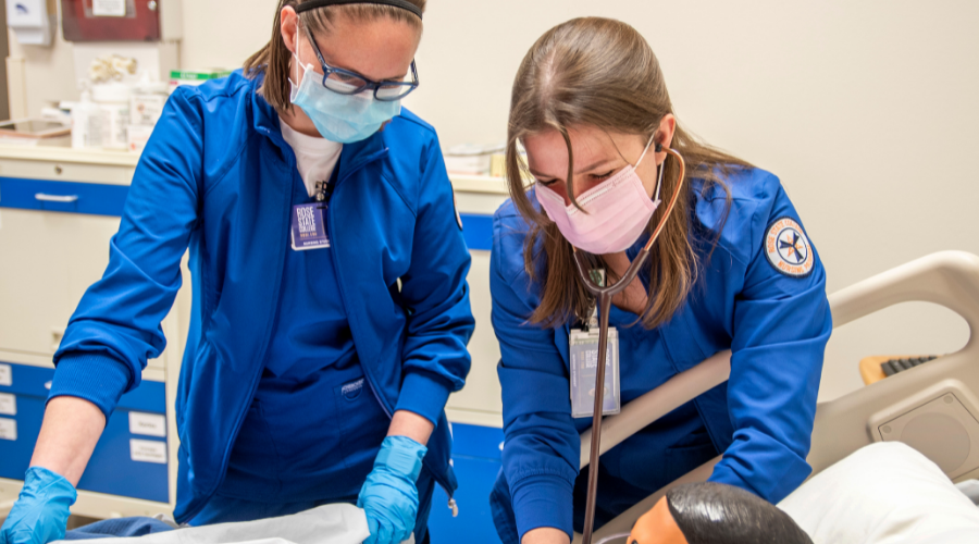 2 students from the Respiratory Therapy program practicing on a CPR mannequin