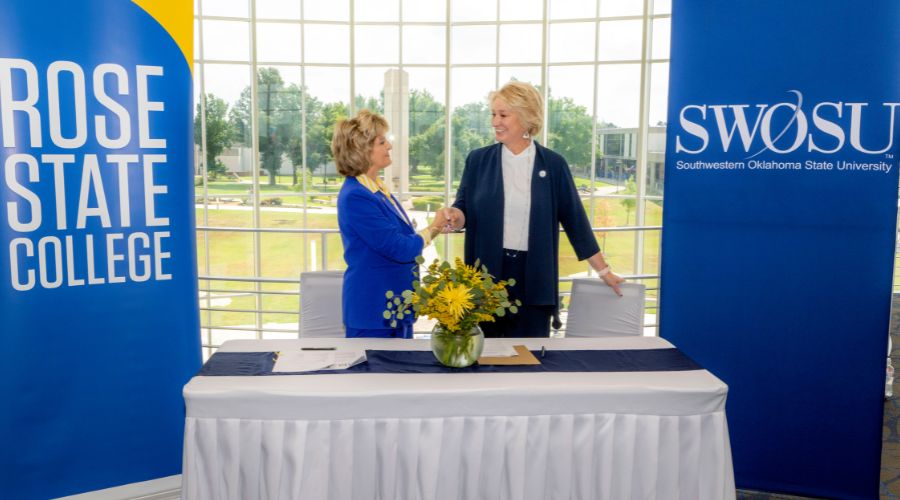 Rose State President Webb and the President of SWOSU sign partnership agreement.