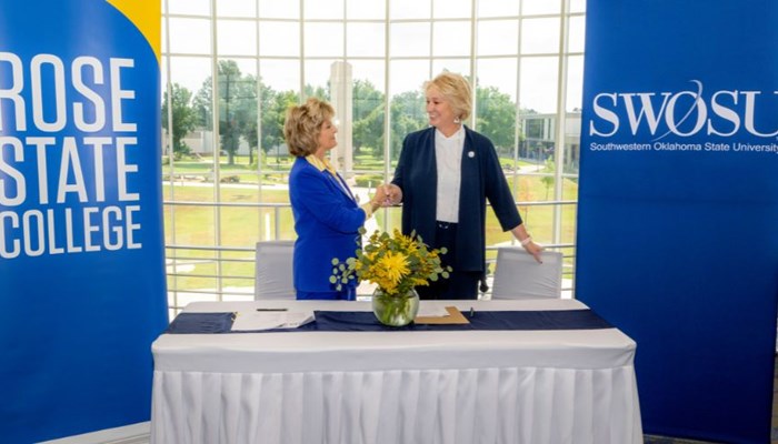Rose State President Webb and the President of SWOSU sign partnership agreement.
