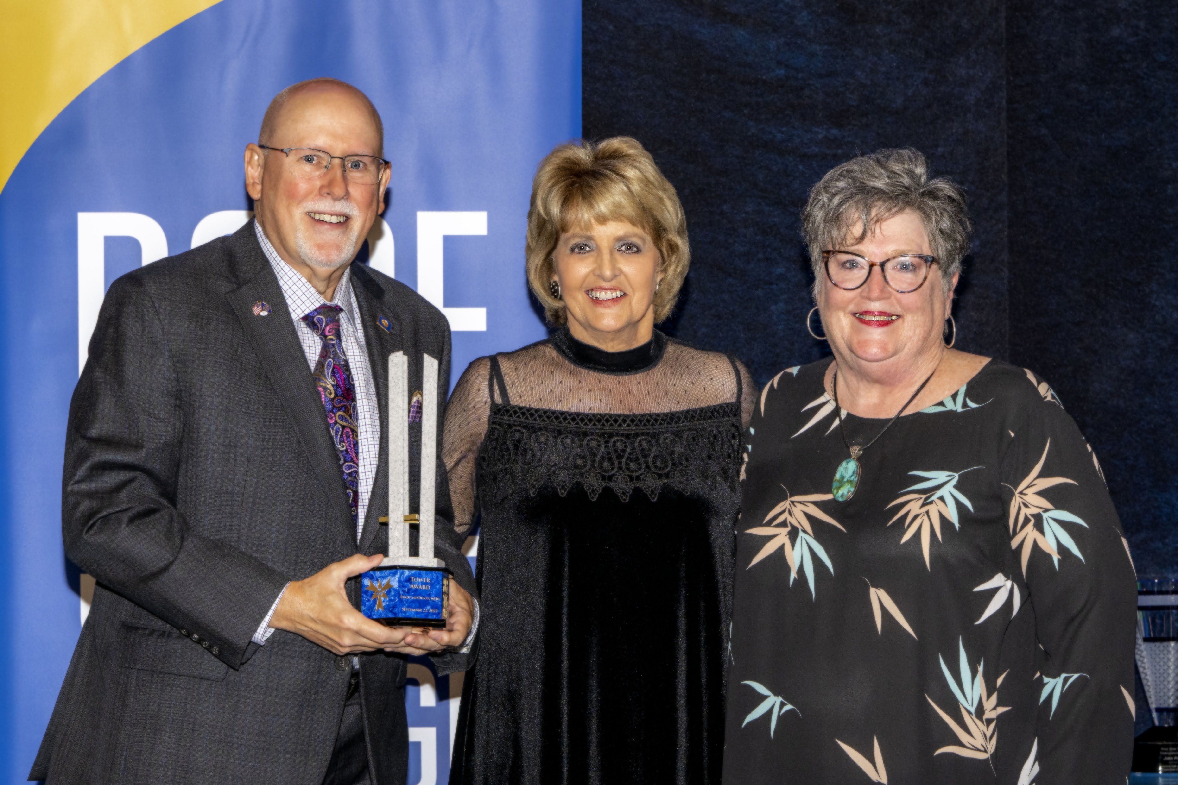 Dick and Glenna Tanenbaum pose with their Tower Award and President Webb.