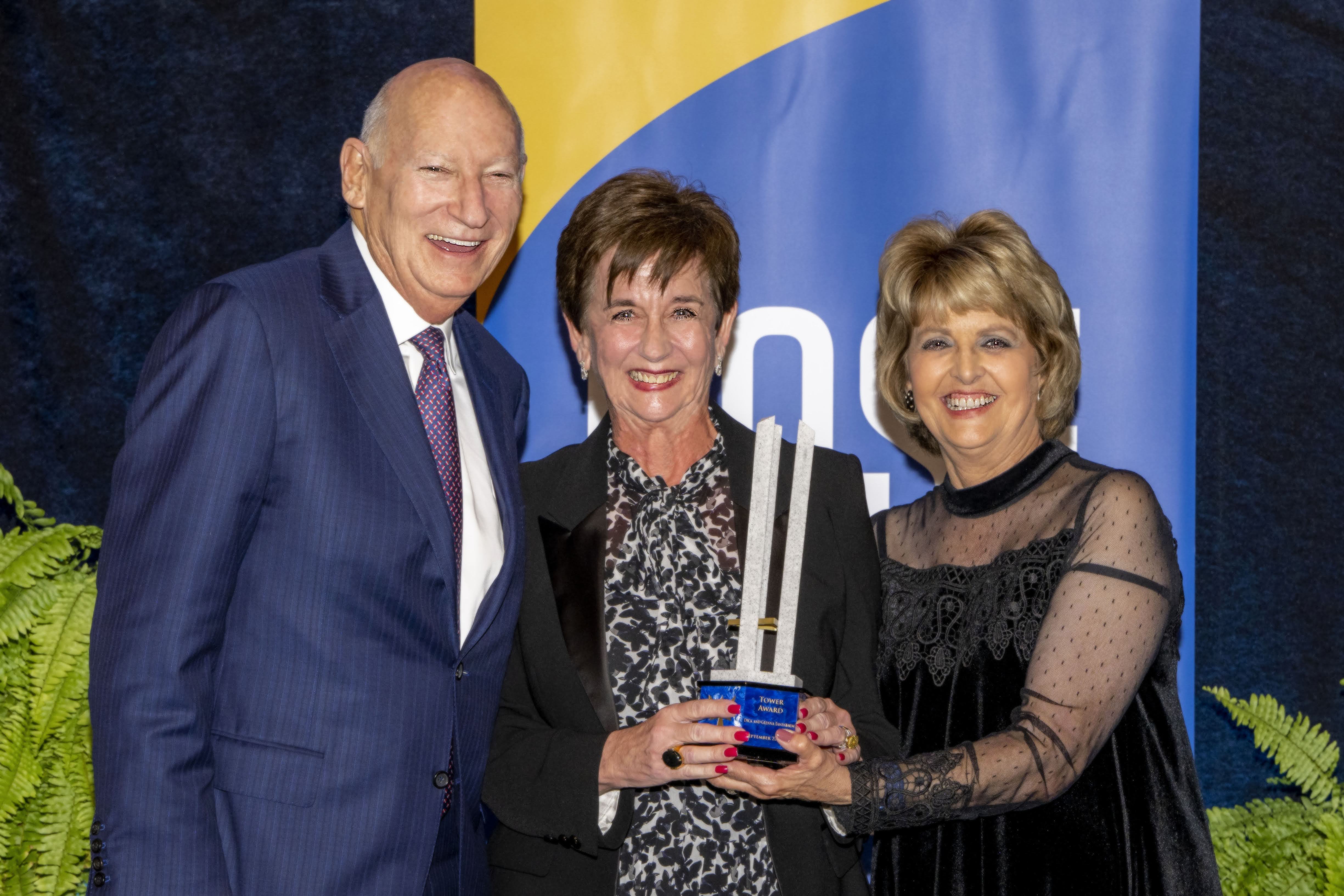 Dick and Glenna Tanenbaum pose with their Tower Award and President Webb.