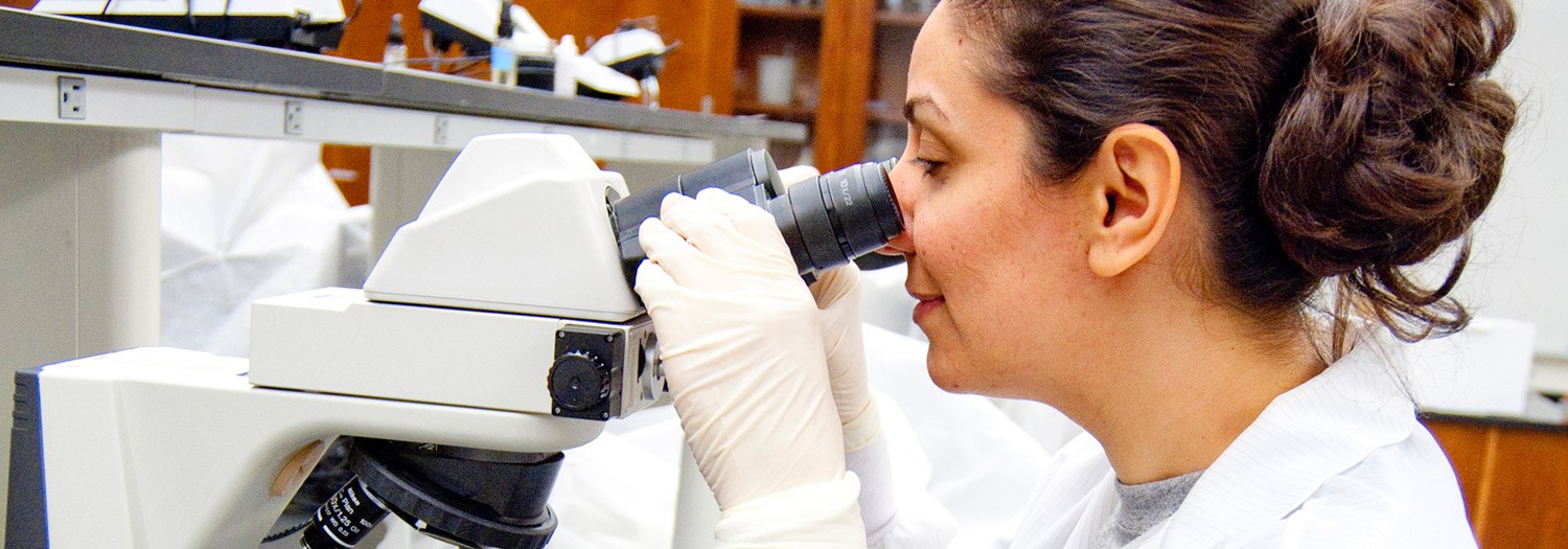 lady looking through a microscope