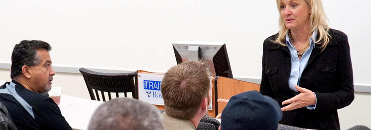 students with professor in classroom setting