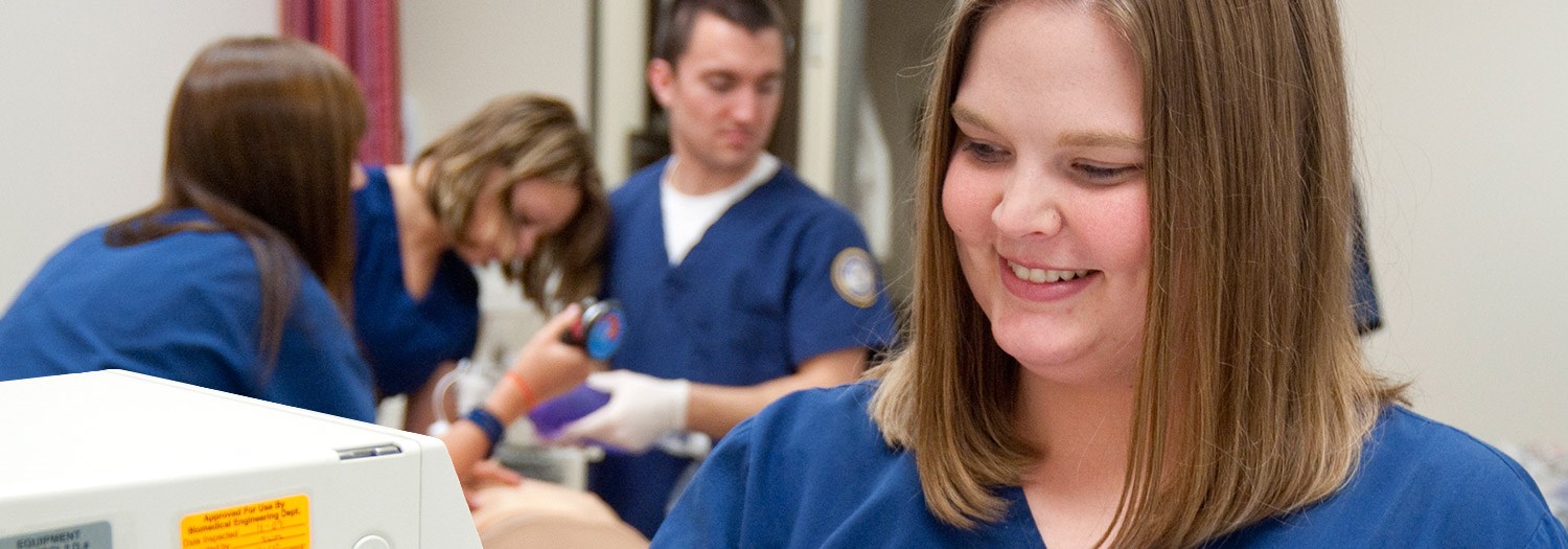 Students working on a lab dummy