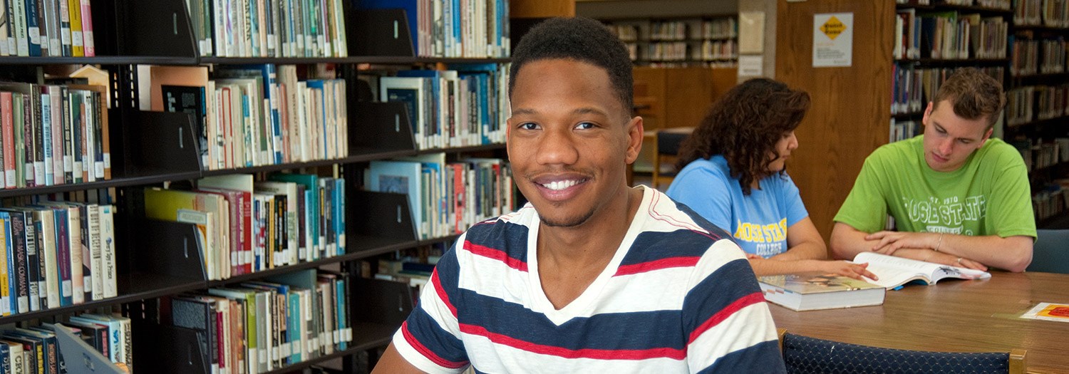 Student standing in the Library