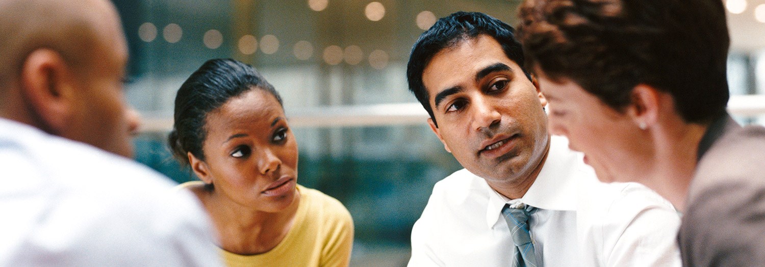 Group of four people deep in discussion