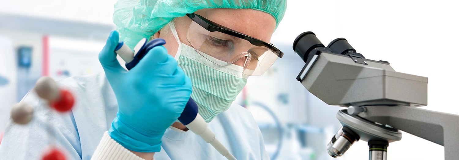 lab workers at a microscope