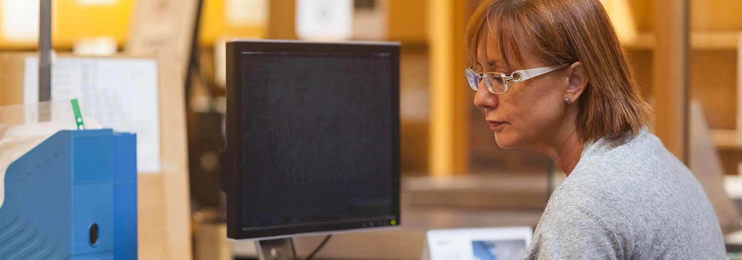 student sitting in front of a computer monitor