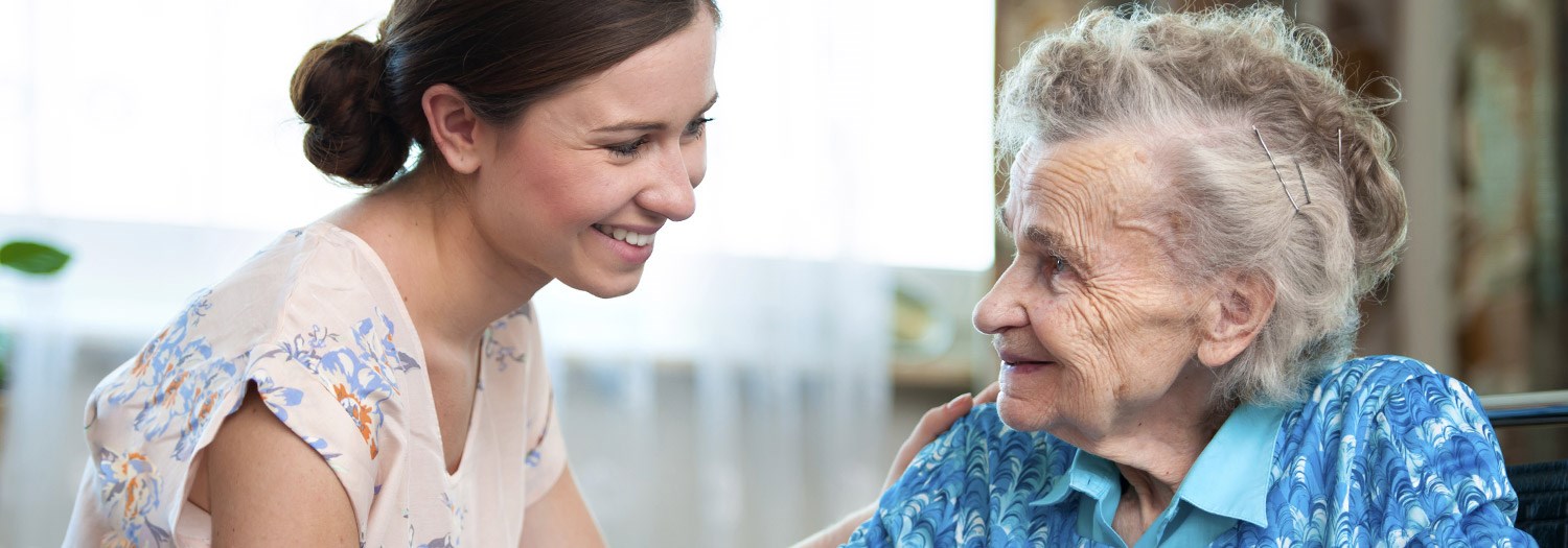 Elderly woman and a young lady who is helping her