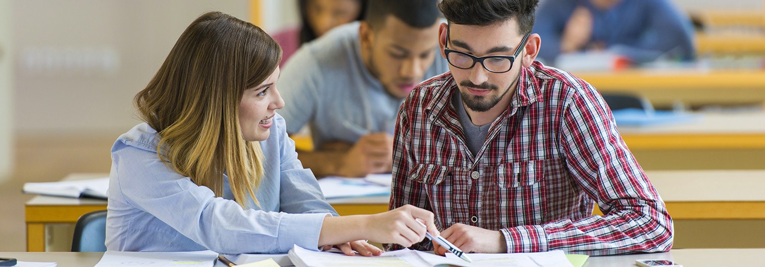 female student discussing materials with male student