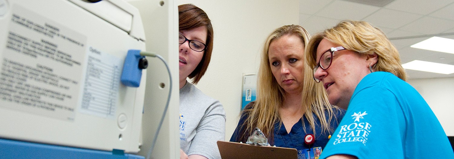 three ladies working at a computer