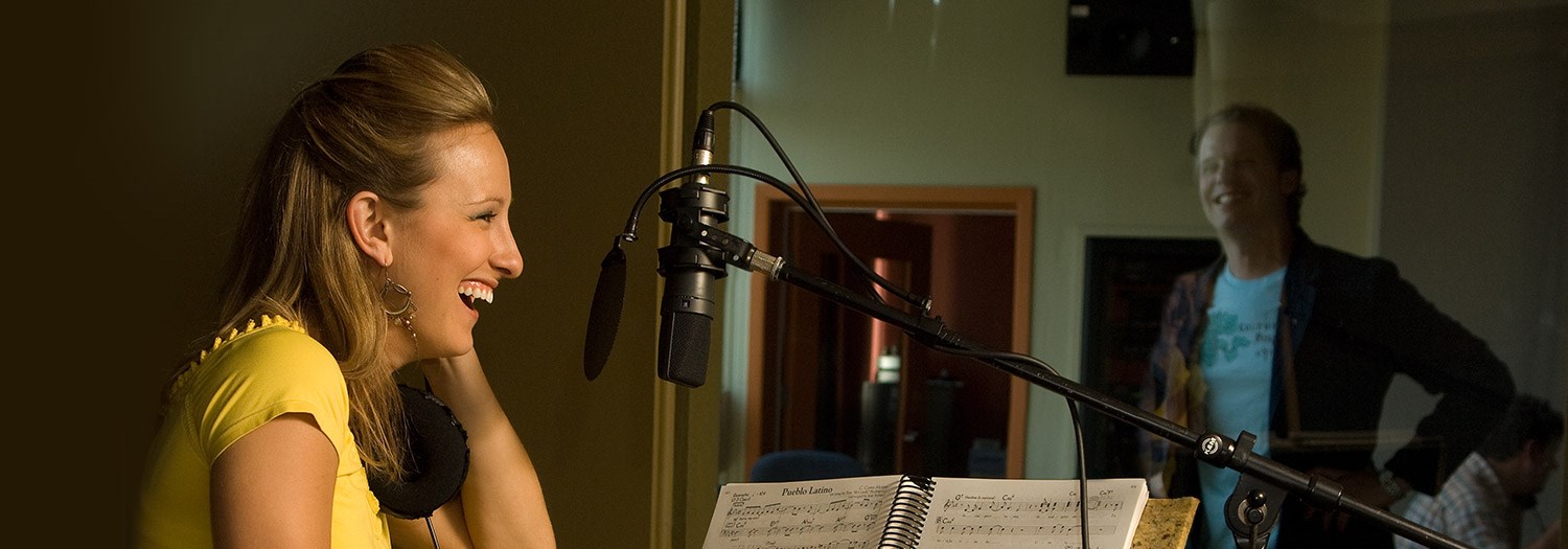 lady at a microphone in a studio