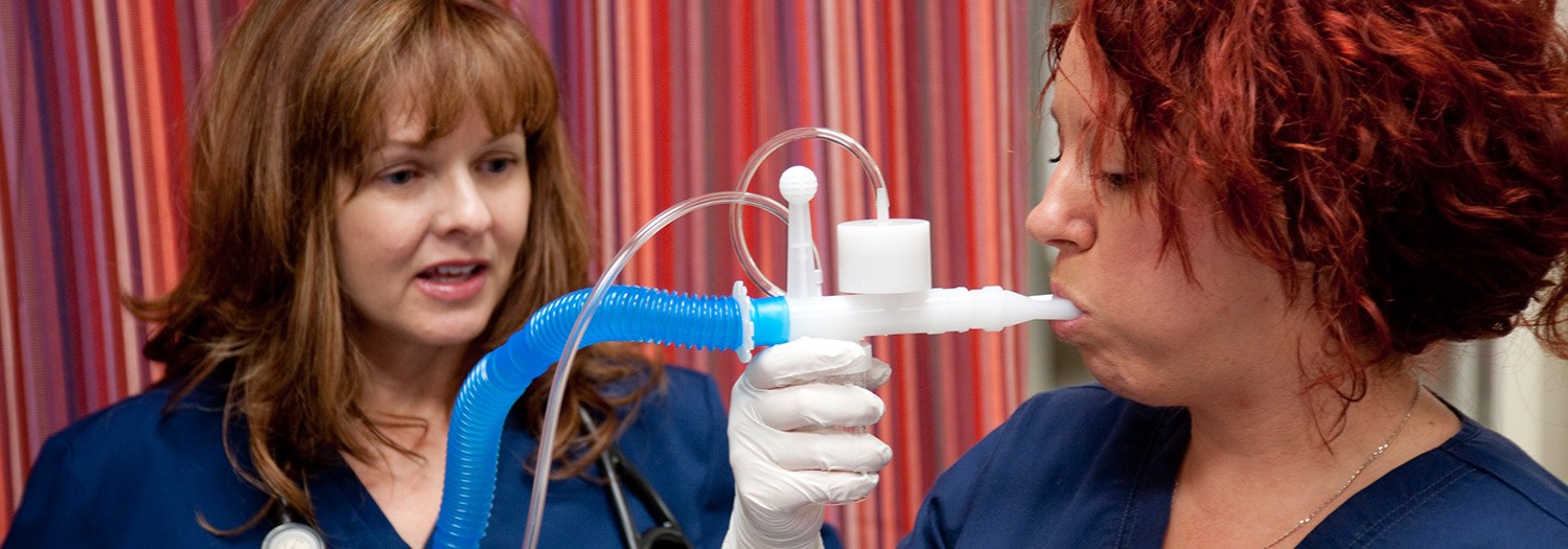 Respiratory therapist student and a person taking a breathing treatment