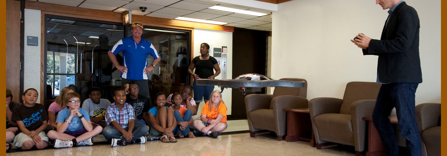 Students observing a drone demonstration