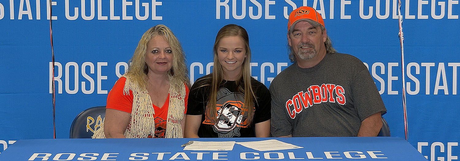 Lauren Mason signs with OSU at a ceremony attended by her parents (pictured as well). 