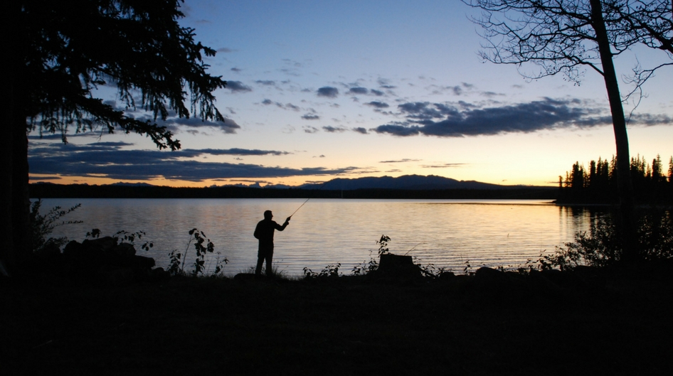 Man fishing alone at sunset