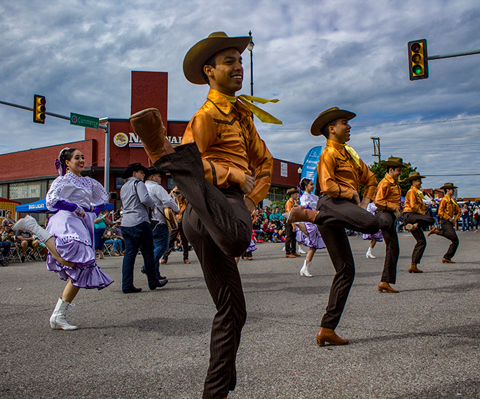 Latin Dancer in street in cowboy attire