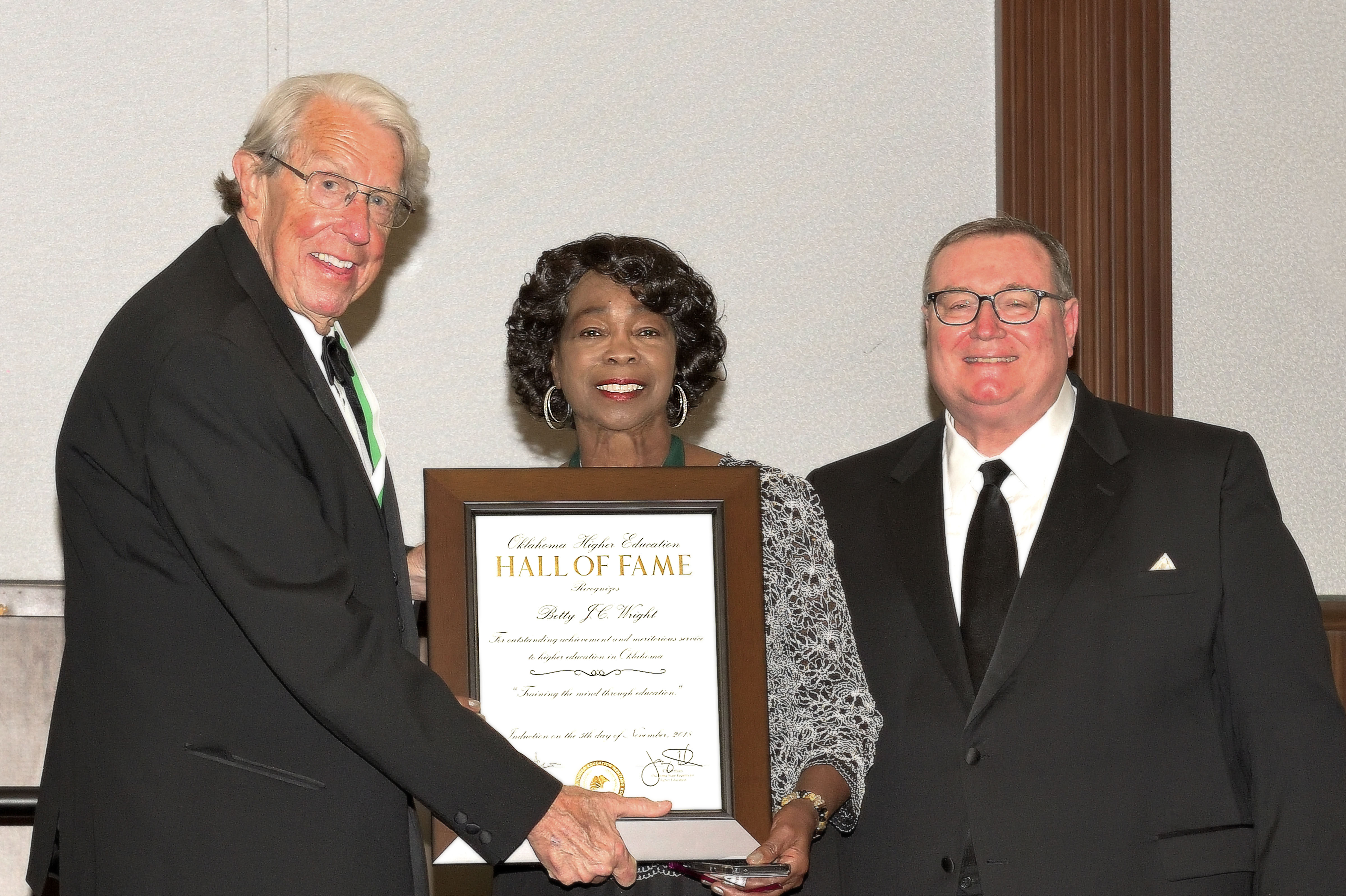 Rose State College Regent Betty J.C. Wright poses with her Oklahoma Education Hall of Fame award with John Feaver, President, Oklahoma Higher Education Heritage Society and Glen D. Johnson, Chancellor of the Oklahoma State Regents for Higher Education.