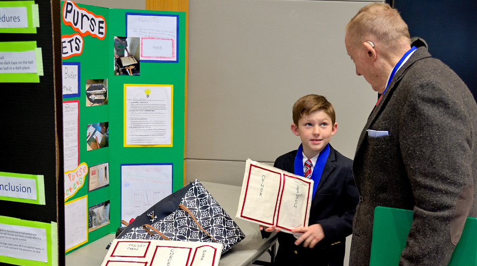 student inventor and judge at invention convention